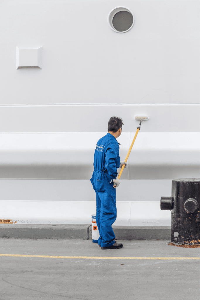 man painting ship exterior